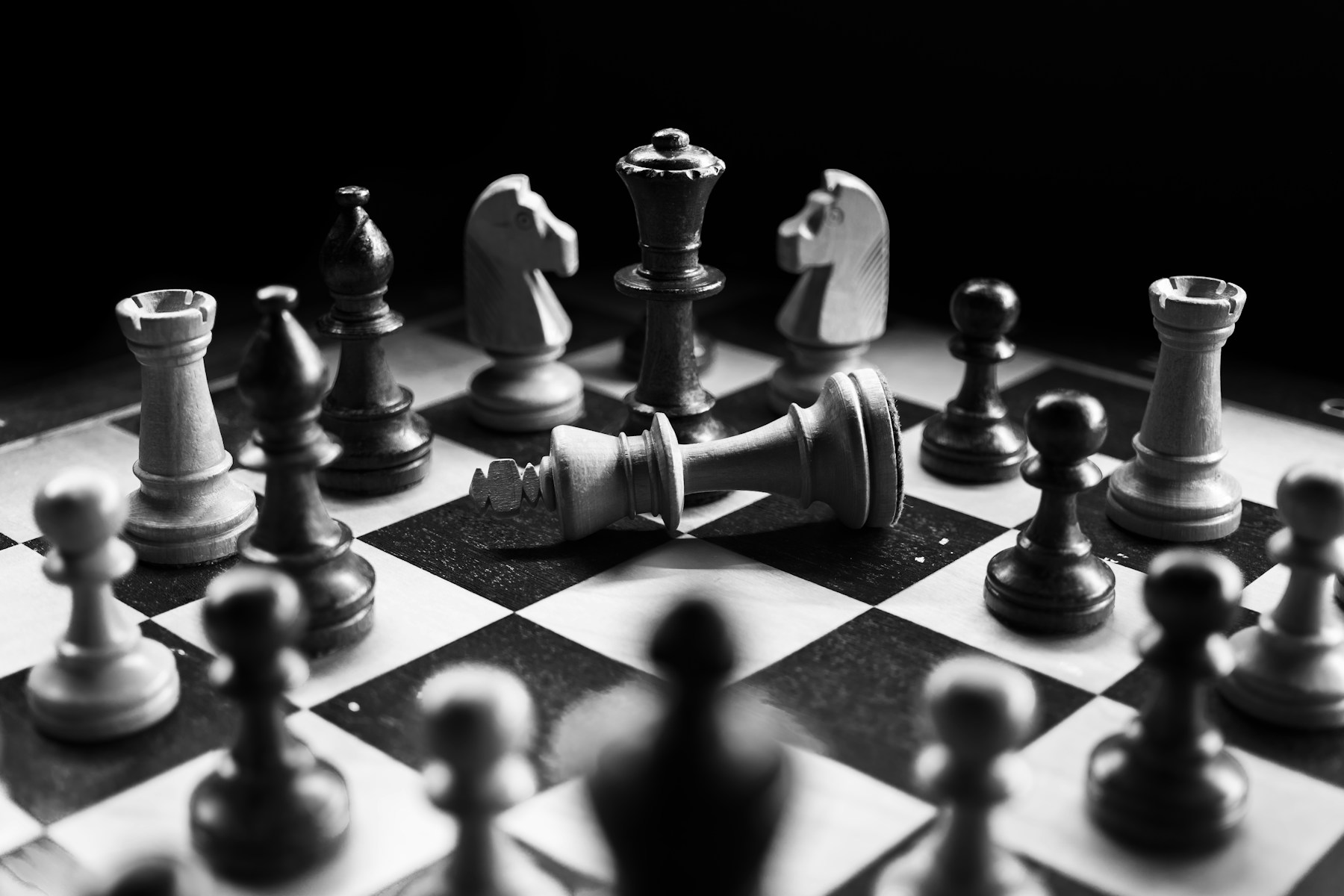 A fallen king on a chessboard
